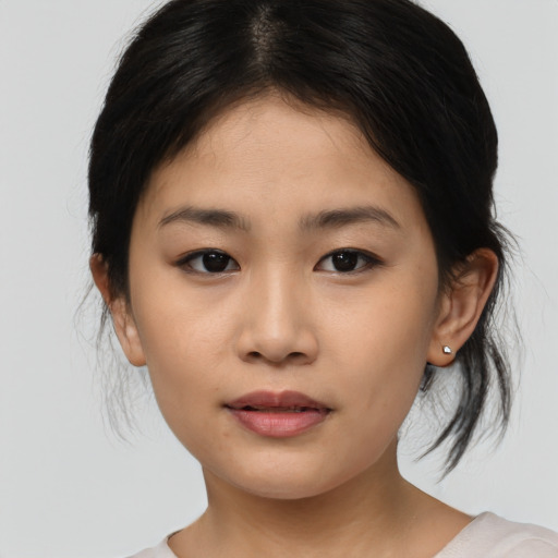 Joyful asian young-adult female with medium  brown hair and brown eyes