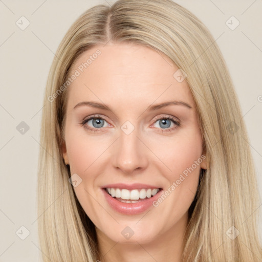 Joyful white young-adult female with long  brown hair and blue eyes