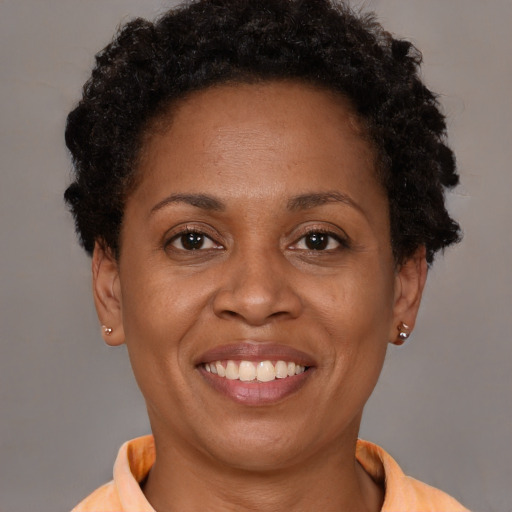 Joyful black adult female with short  brown hair and brown eyes