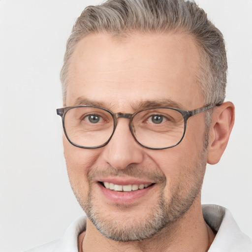 Joyful white adult male with short  brown hair and brown eyes