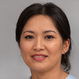 Joyful asian young-adult female with medium  brown hair and brown eyes