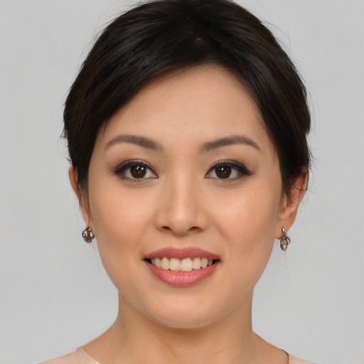 Joyful asian young-adult female with medium  brown hair and brown eyes