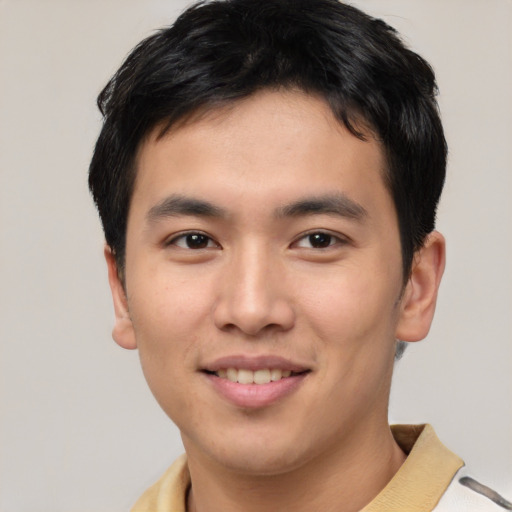 Joyful asian young-adult male with short  brown hair and brown eyes