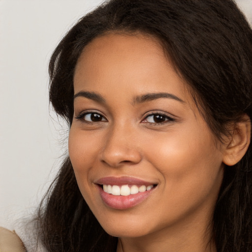 Joyful white young-adult female with long  brown hair and brown eyes