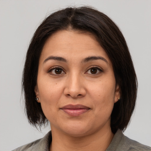 Joyful asian adult female with medium  brown hair and brown eyes