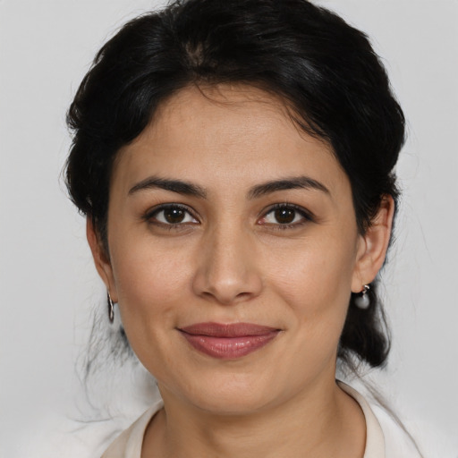 Joyful latino young-adult female with medium  brown hair and brown eyes