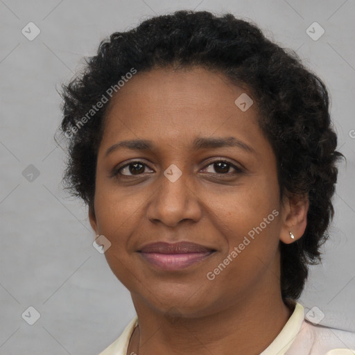 Joyful black adult female with short  brown hair and brown eyes