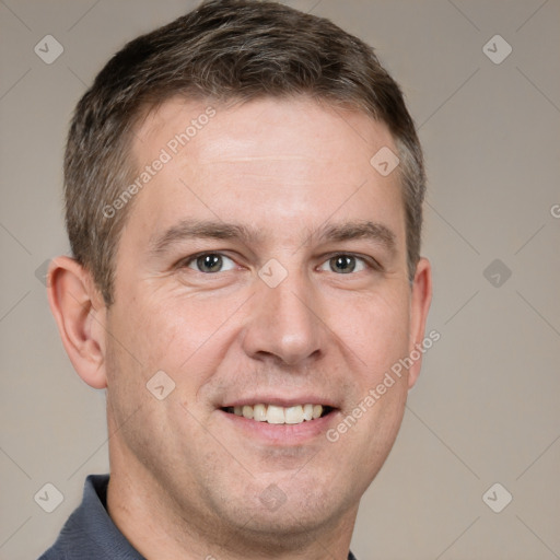 Joyful white adult male with short  brown hair and grey eyes