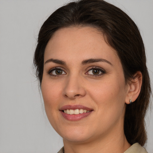 Joyful white young-adult female with medium  brown hair and brown eyes