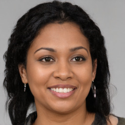 Joyful latino young-adult female with long  brown hair and brown eyes