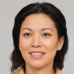 Joyful white adult female with medium  brown hair and brown eyes