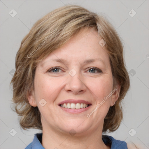 Joyful white young-adult female with medium  brown hair and blue eyes