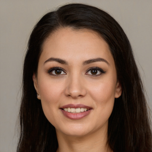 Joyful white young-adult female with long  brown hair and brown eyes