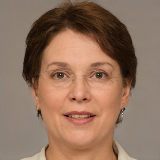 Joyful white adult female with medium  brown hair and green eyes