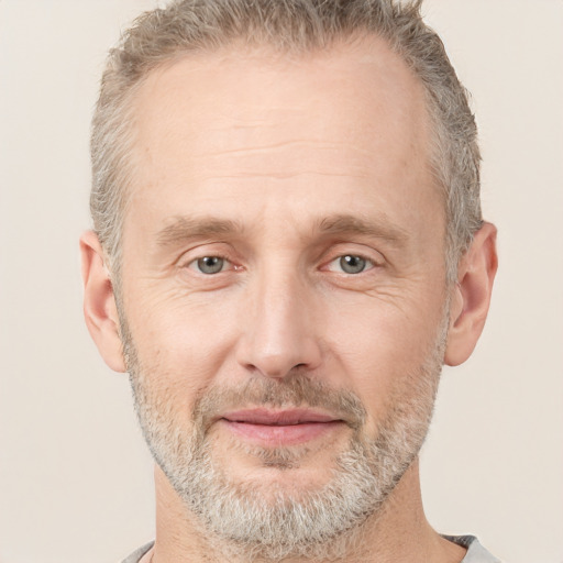 Joyful white adult male with short  brown hair and grey eyes