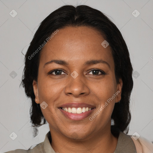 Joyful black adult female with medium  brown hair and brown eyes