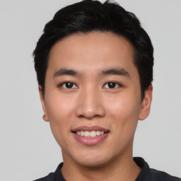 Joyful asian young-adult male with short  black hair and brown eyes