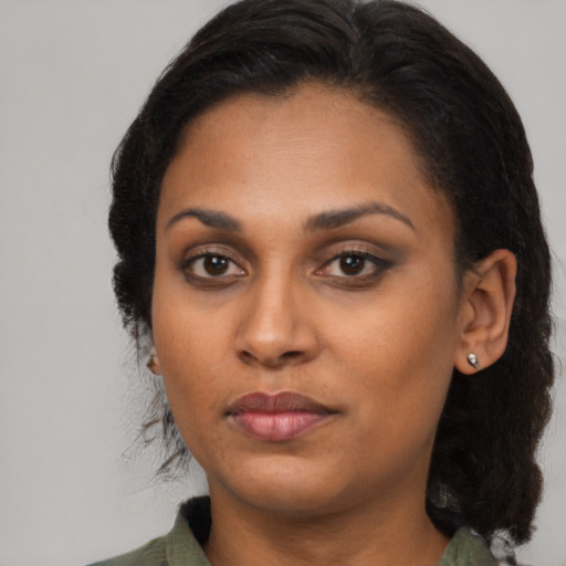 Joyful black young-adult female with medium  brown hair and brown eyes
