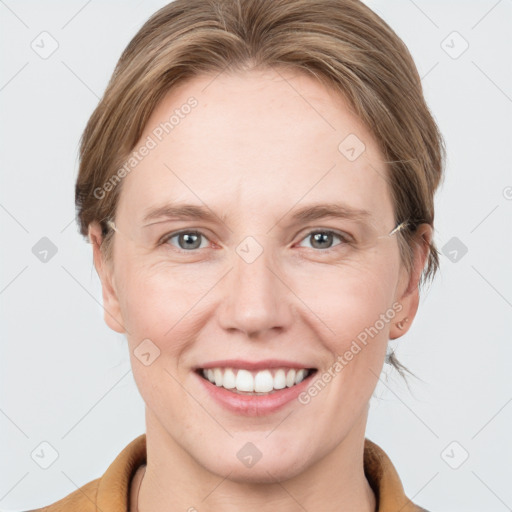 Joyful white adult female with medium  brown hair and grey eyes