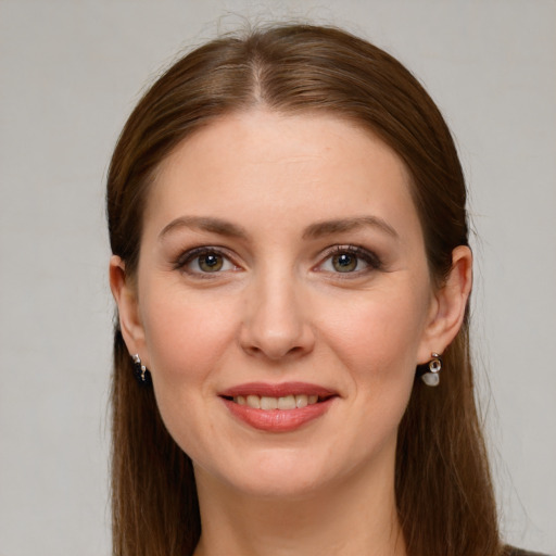 Joyful white young-adult female with long  brown hair and grey eyes