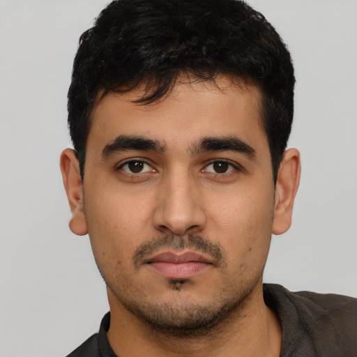 Neutral latino young-adult male with short  black hair and brown eyes