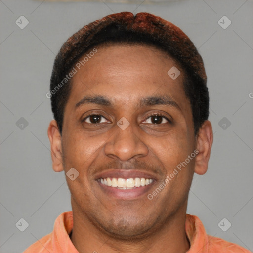 Joyful latino young-adult male with short  brown hair and brown eyes