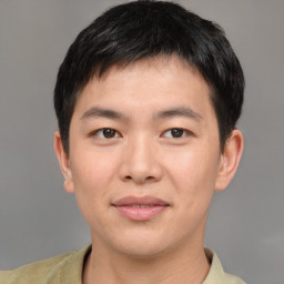 Joyful asian young-adult male with short  brown hair and brown eyes