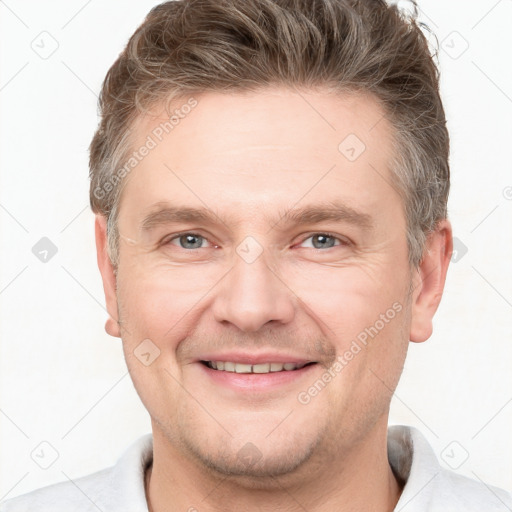 Joyful white adult male with short  brown hair and grey eyes