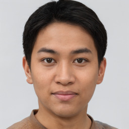 Joyful asian young-adult male with short  brown hair and brown eyes