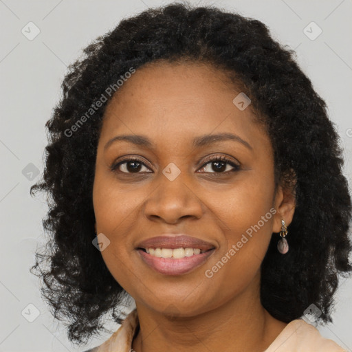 Joyful black young-adult female with long  brown hair and brown eyes