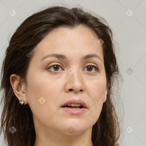 Joyful white young-adult female with long  brown hair and brown eyes