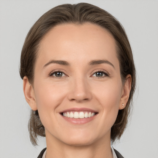 Joyful white young-adult female with medium  brown hair and brown eyes