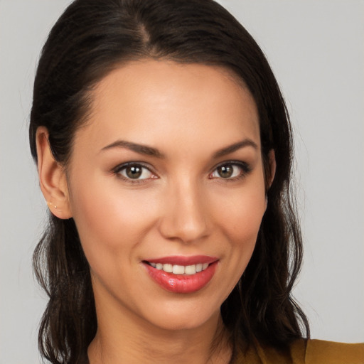 Joyful white young-adult female with long  brown hair and brown eyes