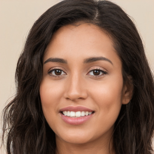 Joyful white young-adult female with long  brown hair and brown eyes