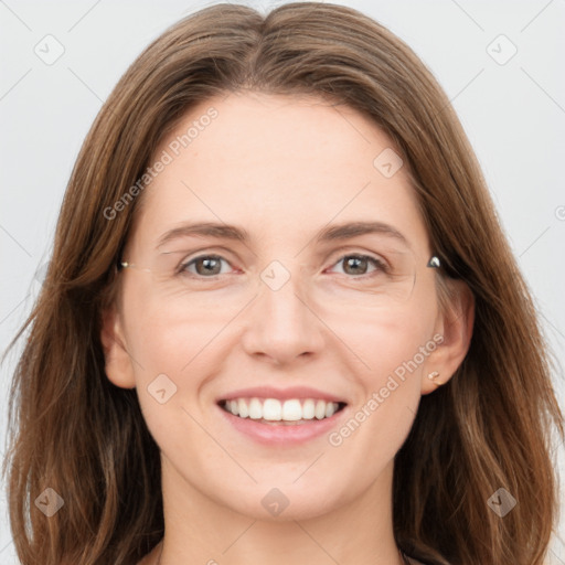 Joyful white young-adult female with long  brown hair and grey eyes