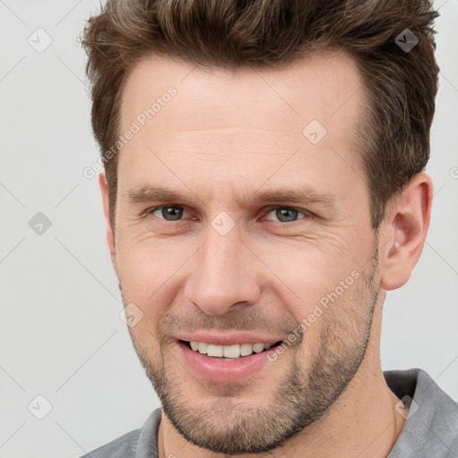 Joyful white adult male with short  brown hair and grey eyes