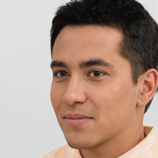 Joyful white young-adult male with short  black hair and brown eyes