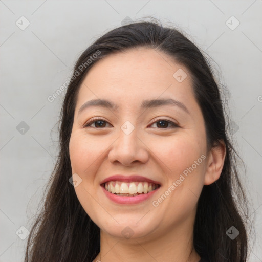 Joyful white young-adult female with long  brown hair and brown eyes