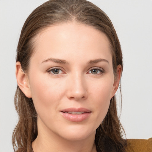 Joyful white young-adult female with long  brown hair and grey eyes