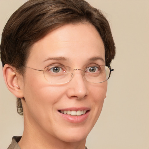 Joyful white adult female with medium  brown hair and grey eyes