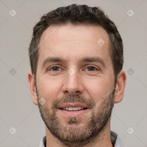 Joyful white adult male with short  brown hair and brown eyes