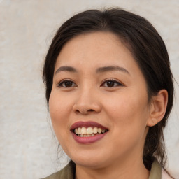 Joyful asian young-adult female with medium  brown hair and brown eyes