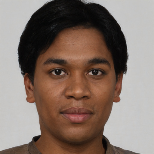 Joyful black young-adult male with short  black hair and brown eyes