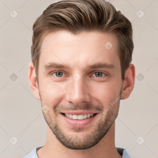 Joyful white young-adult male with short  brown hair and grey eyes