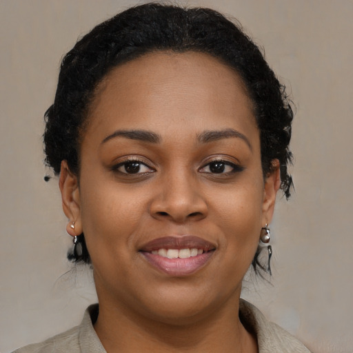 Joyful black young-adult female with medium  brown hair and brown eyes