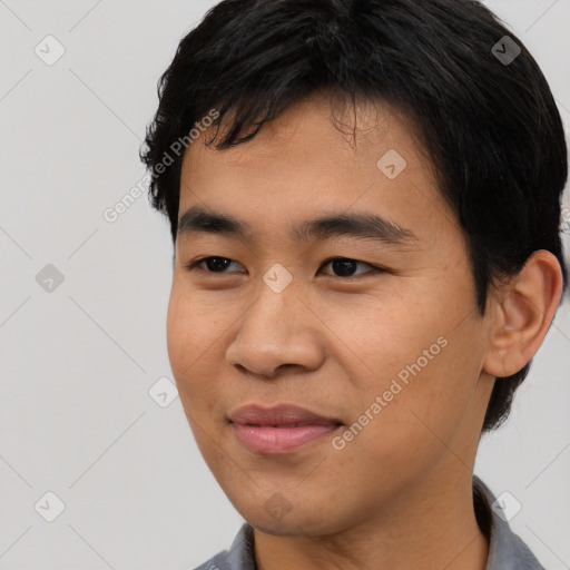 Joyful asian young-adult male with short  black hair and brown eyes