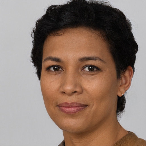 Joyful latino adult female with short  brown hair and brown eyes