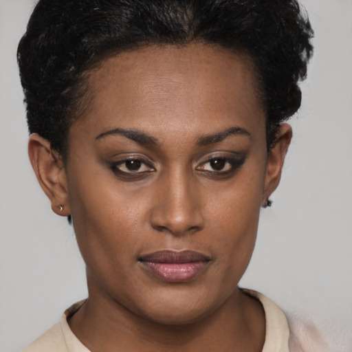 Joyful black young-adult female with short  brown hair and brown eyes