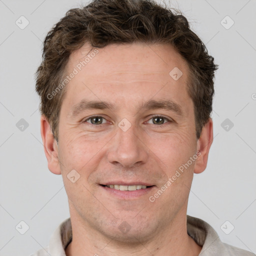 Joyful white adult male with short  brown hair and grey eyes