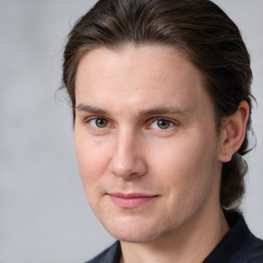 Joyful white adult male with medium  brown hair and brown eyes